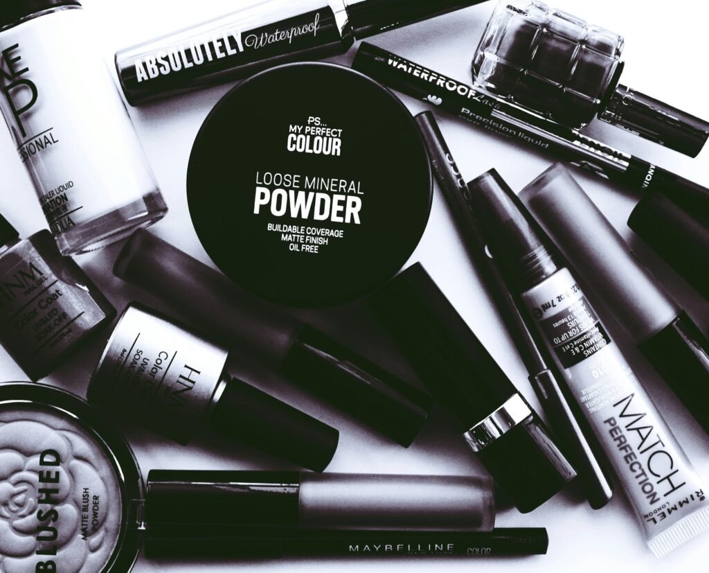 Elegant monochrome flatlay showcasing a collection of beauty products and cosmetics.