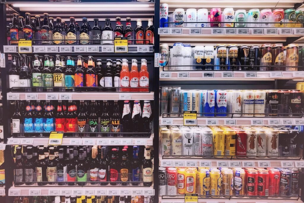 Wide variety of bottled and canned beers displayed on store shelves in Shanghai, China.