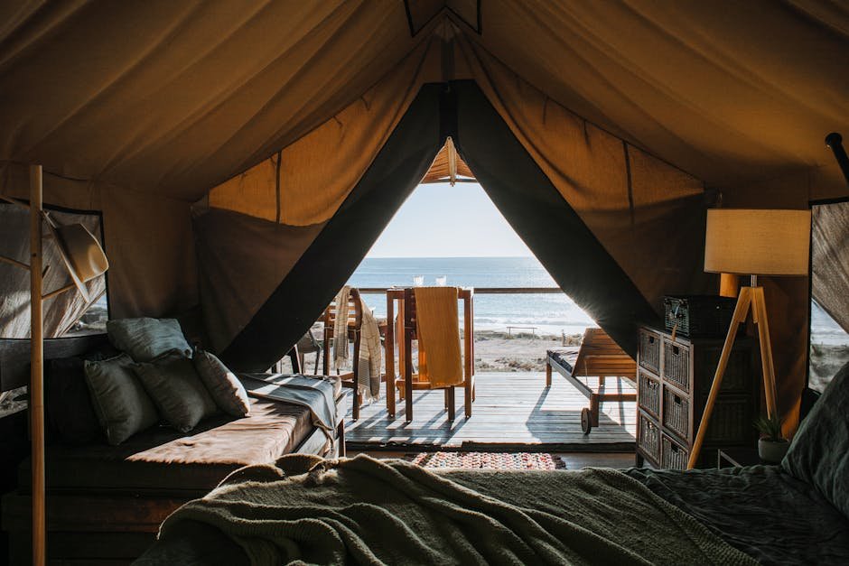 A luxurious tent setup with a view of the ocean, perfect for a peaceful getaway.