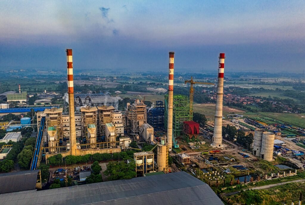 Aerial view of an industrial plant with smokestacks in Serang, Banten, Indonesia during daylight.