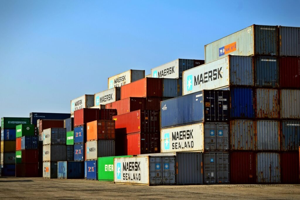 Colorful stacked shipping containers at a port exemplify global logistics.